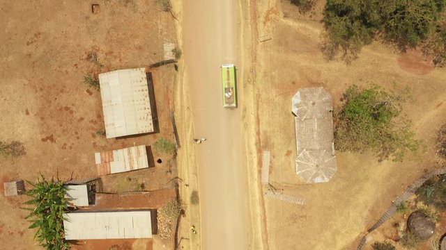 Overhead aerial view of public bus driving through Dorze village in mountains near Arba Minch in South Ethiopia