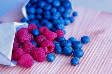 Berries frame on a wooden background, blueberry, raspberries