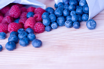 Berries frame on a wooden background, blueberry, raspberries