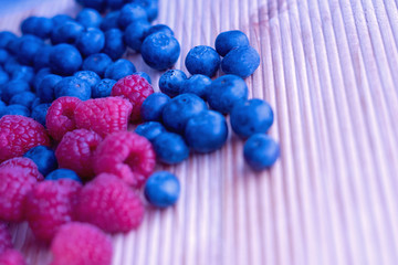 Berries frame on a wooden background, blueberry, raspberries