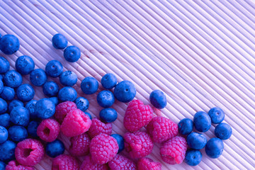 Berries frame on a wooden background, blueberry, raspberries