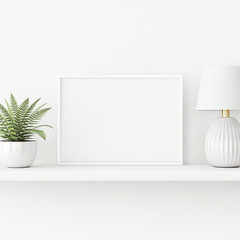 Interior poster mockup with horizontal white frame standing on the table with plant in pot and lamp on empty wall background. 3D rendering, illustration.