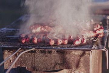 Sausages on grill with smoke