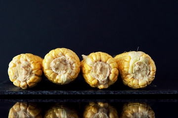 Ripe yellow corn on a dark background