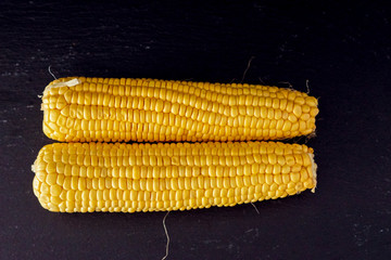 Ripe yellow corn on a dark background