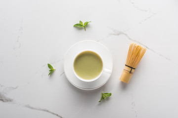 Fototapeta na wymiar top view of matcha tea with mint on white table