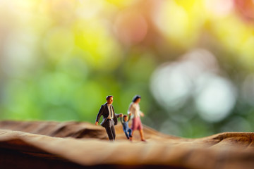 Love and Happy Family. Work Life Balance Concept. Miniature of Father, Mother and Son holding Hands...