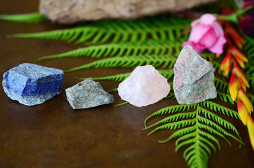 Rough crystals in woman's hand with natural lighting. Raw Rose Quartz, Raw Lapis Lazuli, Raw...