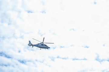Fototapeta na wymiar St. Petersburg, Russia - August, 14, 2019: helicopter flies in the sky over St. Petersburg