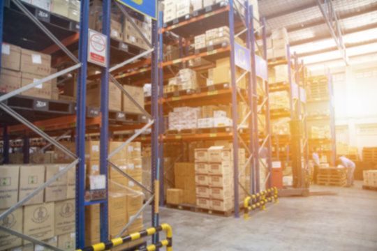 Blur Warehouse inventory product stock for logistic background, Long shelves with a variety of boxes (Lights background)