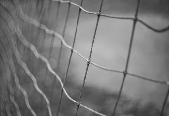 Closeup Rope old net from a football goal with knots and a blurred background.