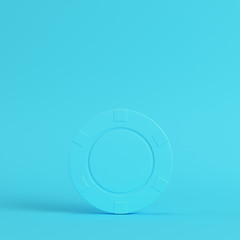 Casino chip on bright blue background in pastel colors