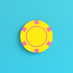 Yellow casino chip on bright blue background in pastel colors