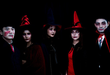 Portrait of young people in Halloween costume with scary makeup style in dark background