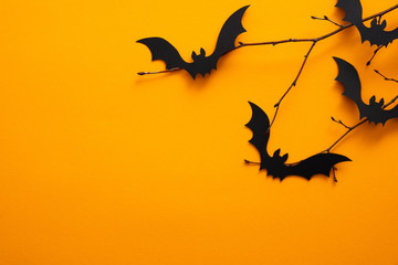 Halloween holiday concept. Halloween bats on orange background. Halloween party greeting card...