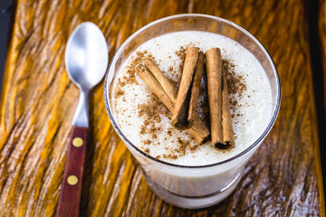 Creamy rice pudding sprinkled with cinnamon, typical Brazilian dessert.