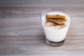 Creamy rice pudding sprinkled with cinnamon, typical Brazilian dessert.