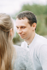 journey outdoors in the summer. smiling portrait of a man on the lake.