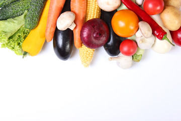 Set of different fresh vegetables on a white background top view.