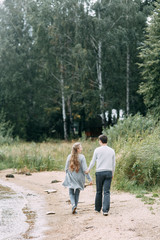 Obraz premium travel walk in the woods. young couple walking on the lake.