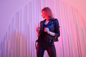 Beautiful girl dancing in retro wave on the neon light