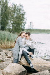 Fototapeta premium a walk in the woods by the pier. young couple walking on the lake.