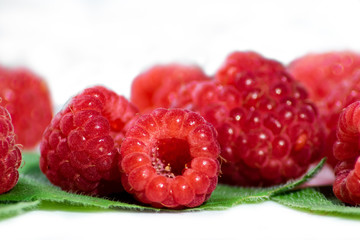 raspberry and mint leaves on white background, close-up