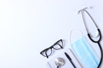 Doctor's desk top view. Set of different doctor accessories on a colored background. Pills,...