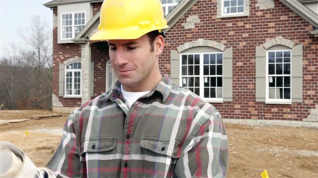 Construction: Home Builder Reads Blueprints And Walks Off Camera
