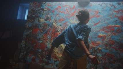 Talented Female Artist Energetically, Enthusiastically Using Paint Brush She Creates Modern Masterpiece of the Oil Painting. Creative Studio with Large Canvas of Striking Colors. Low Tilt Angle Shot - Powered by Adobe
