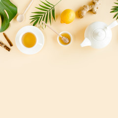Herbal tea with mint, ginger, lemon, honey and other herbs on yellow background. Flat lay, top view.