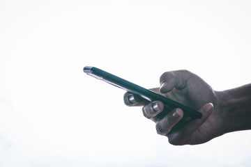 Side view of hands is touching the screen against a white background.