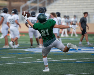 Fototapeta premium Great action photos of high school football players making amazing plays during a football game