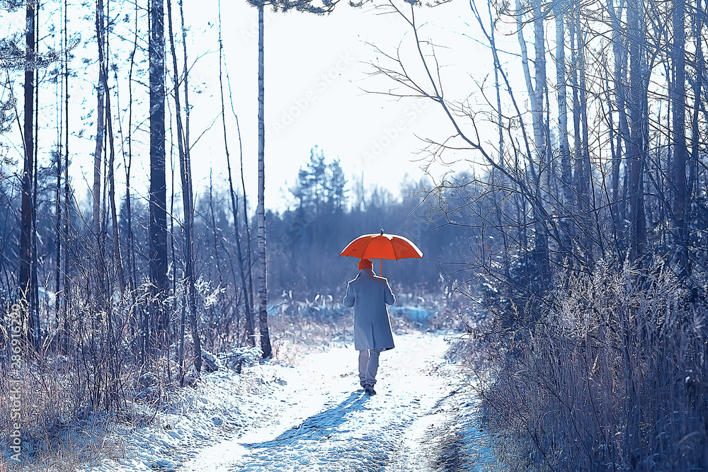 Wall mural winter walk with an umbrella / man in a coat with an umbrella, walk against the backdrop of the winter landscape, winter view