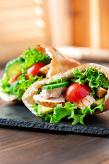 Pita stuffed chicken, tomatoes, lettuce and cucumber. Delicious Mediterranean food. Middle Eastern cuisine.