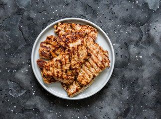 Turkey grilled chops on dark background, top view