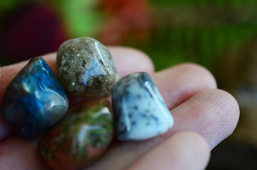 Witches mini crystal set Chrysocolla, Dendritic Agate, Unakite and Ocean Jasper. Small mixture of tumbled crystals. Higher healing bundle. Woman holding crystals in hands. Mix of colors and patterns.