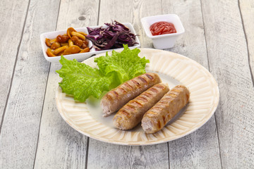 Grilled sausages served mushrooms and cabbage