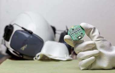 Hand holding tiny electronic circuit board inserting to the socket, abstract technology background,...