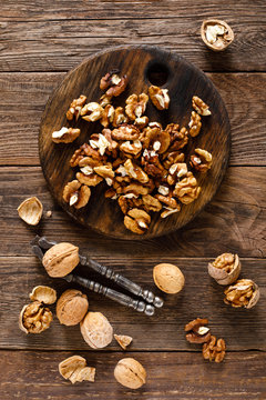 Walnuts. Kernels and whole nuts on wooden rustic table, top view