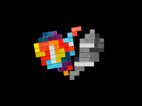 Broken multicolored mosaic heart isolated on black background