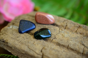 Obraz na płótnie Canvas Tumbled Red Goldstone, Blue Goldstone, and Green Goldstone! Sparkling healing crystals, magical witchy stones for reiki healing and energy work! Rainbow of tumbled stones natural lighting photoagraphy