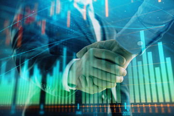 Multi exposure of forex graph on abstract background with two businessmen handshake. Concept of...