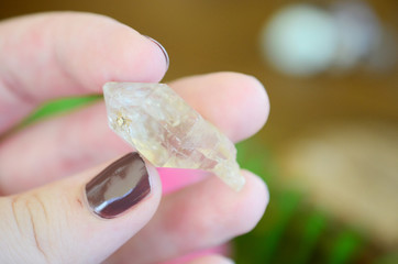 Clear quartz point on wood table in natural lighting. Woman's hand - High Quality Clear Quartz healing stone, One of a Kind Quartz Point, great for a reiki healing! Unique formations, Quartz Scepter.