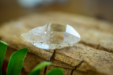 Clear quartz point on wood table in natural lighting. Woman's hand - High Quality Clear Quartz healing stone, One of a Kind Quartz Point, great for a reiki healing! Unique formations, Quartz Scepter.