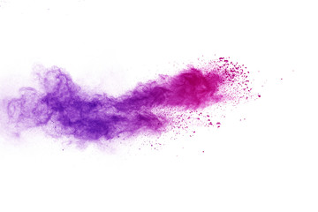 Freeze motion of purple color powder exploding on white background.
