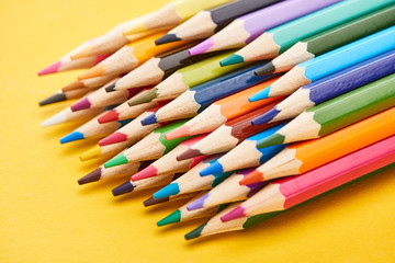 Fototapeta premium Set of sharpened color pencils on yellow background