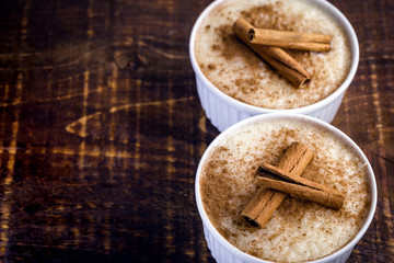 Sweet decorated with cinnamon. Brazilian tasty dessert on wood background.