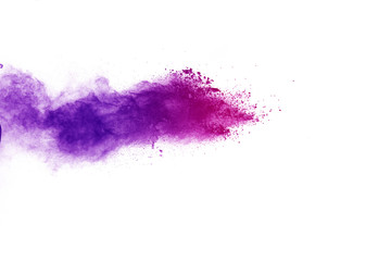Freeze motion of purple color powder exploding on white background.