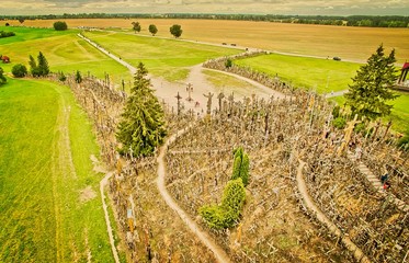 Hill of crosses in Siauliai town from above with tourists.Lithuania.